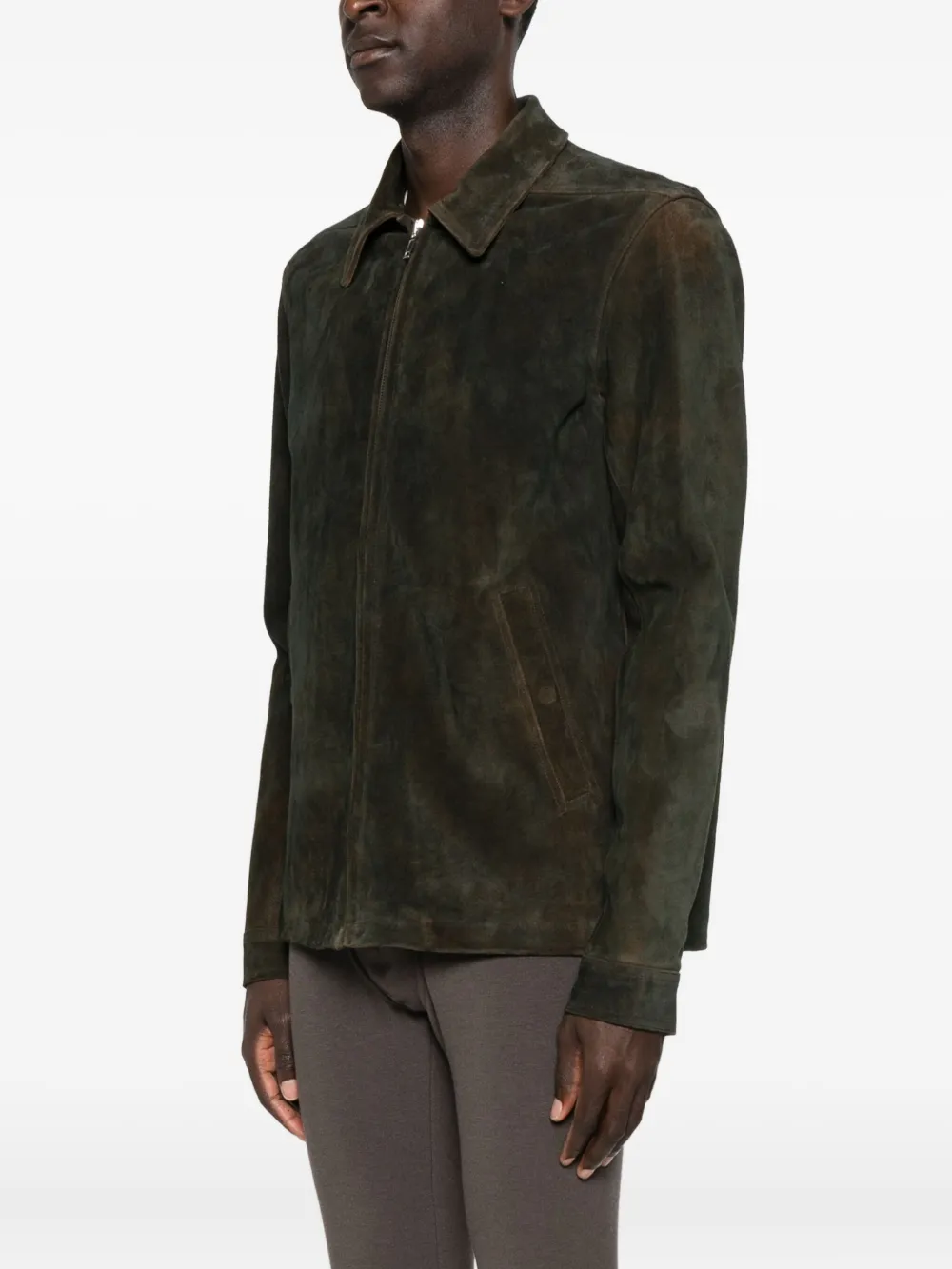 Green jacket worn by a person, showing the jacket's fit