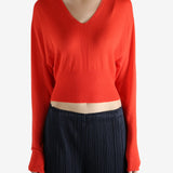 Red long-sleeve top worn by a person, showing the top fit