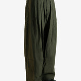 Green pants worn by a person, showing the pants' fit
