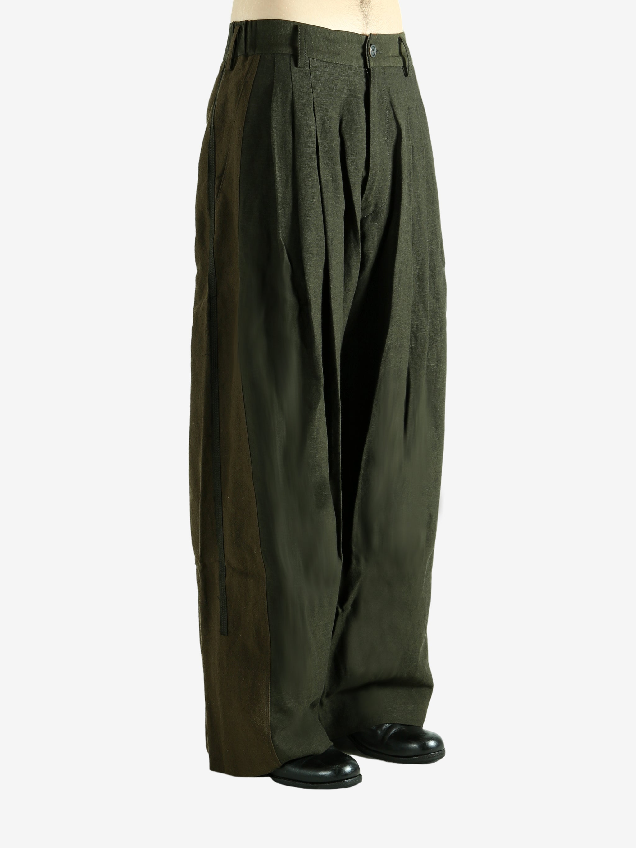 Green pants worn by a person, showing the pants' fit