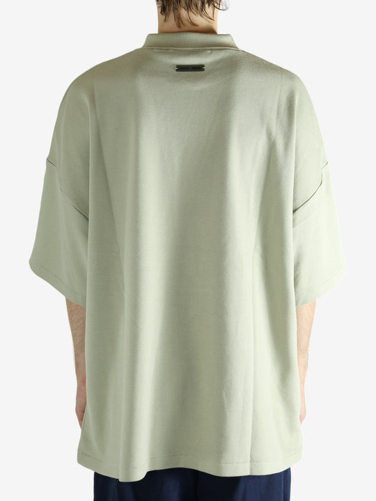 Green shirt worn by a person, showing the shirt's fit