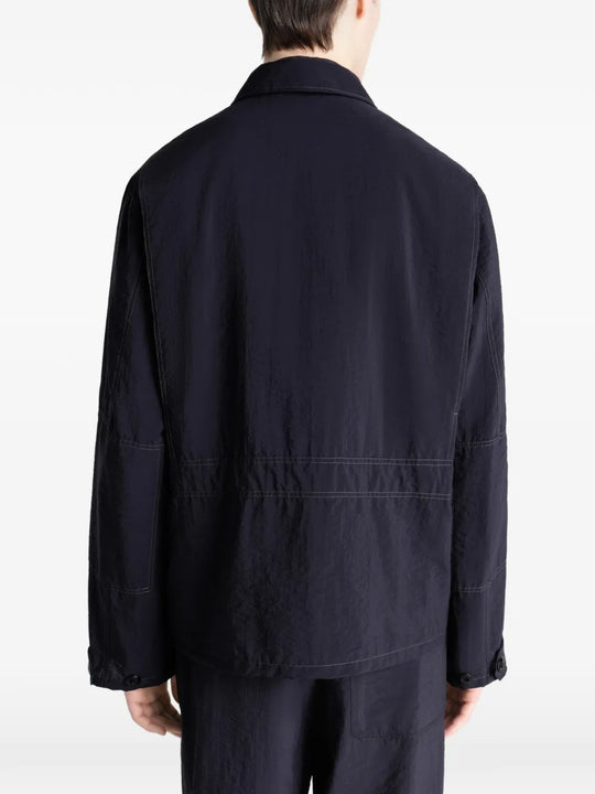 Black jacket worn by a person, showing the jacket's fit