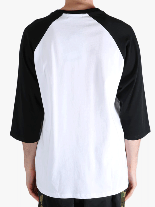 White t-shirt worn by a person, showing the t-shirt's fit