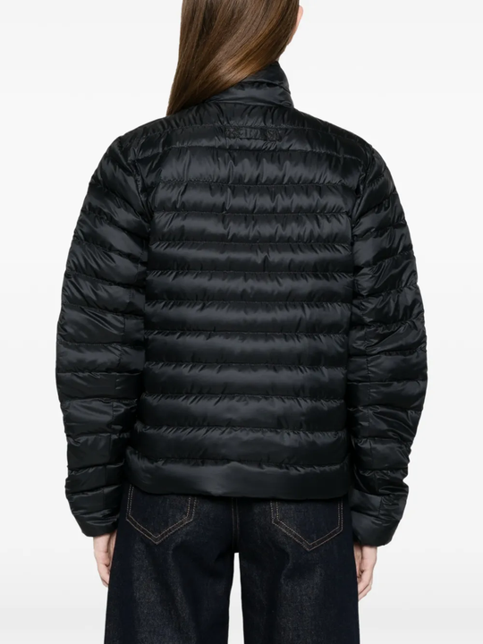 black jacket worn by a person, showing the jacket fit