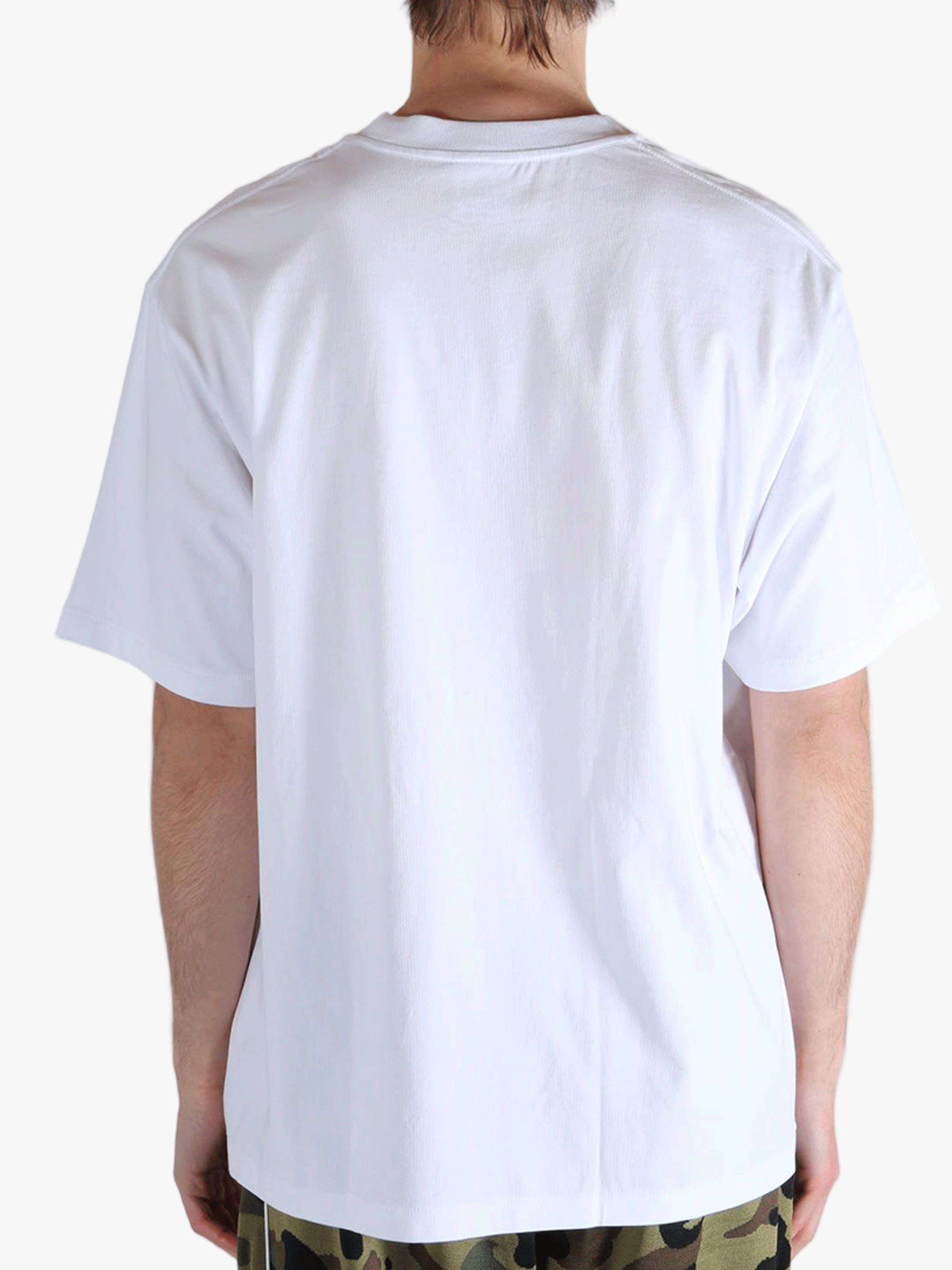 White t-shirt worn by a person, showing the t-shirt's fit