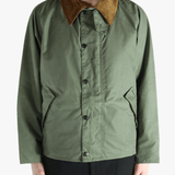 Green jacket worn by a person, showing the jacket fit