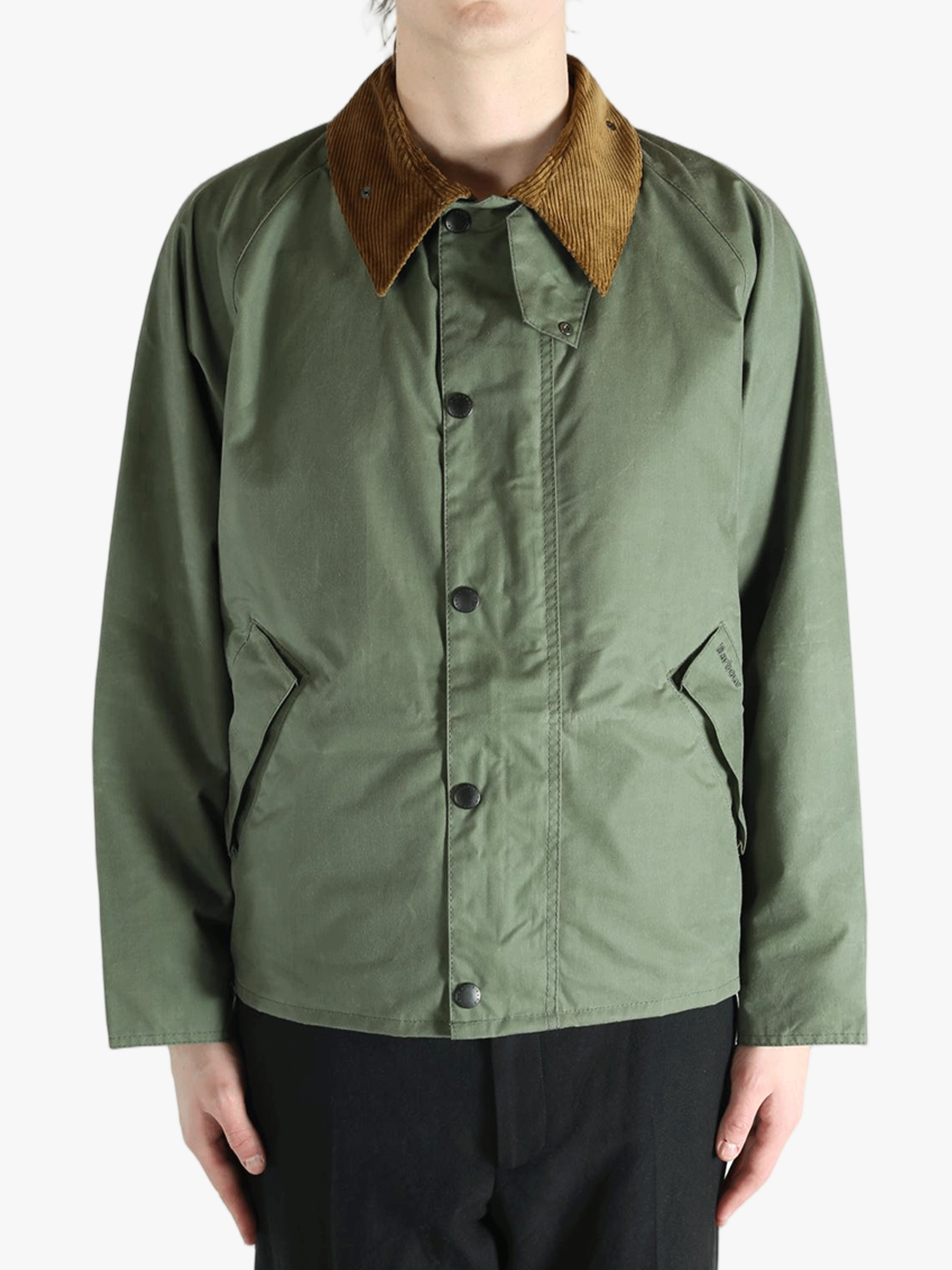 Green jacket worn by a person, showing the jacket fit
