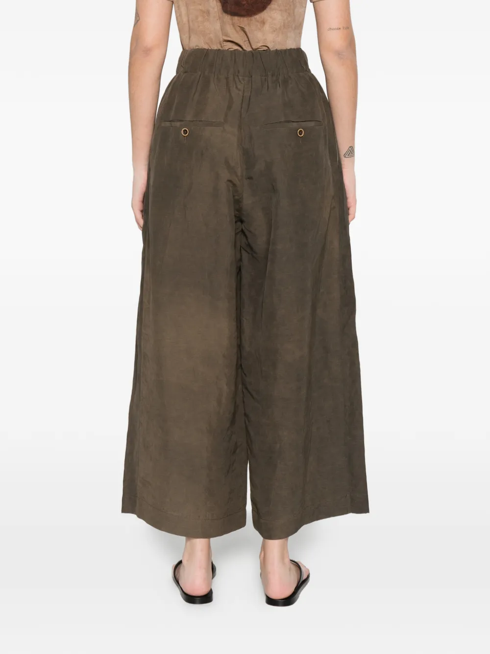 Brown pants worn by a person, showing the pants's fit