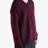 Red sweater worn by a person, showing the sweater fit