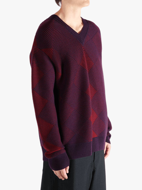 Red sweater worn by a person, showing the sweater fit