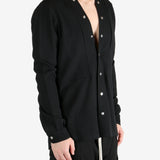 Black shirt worn by a person, showing the shirt's fit