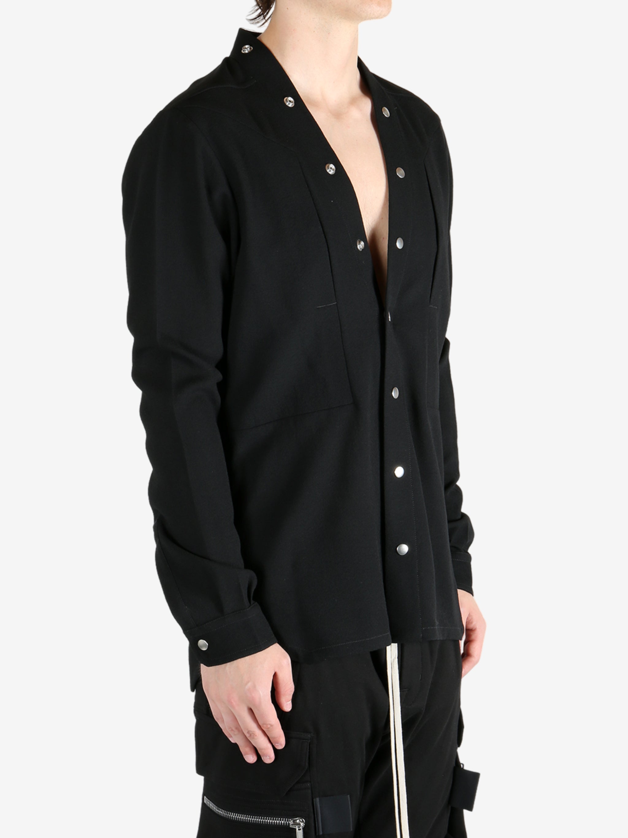 Black shirt worn by a person, showing the shirt's fit