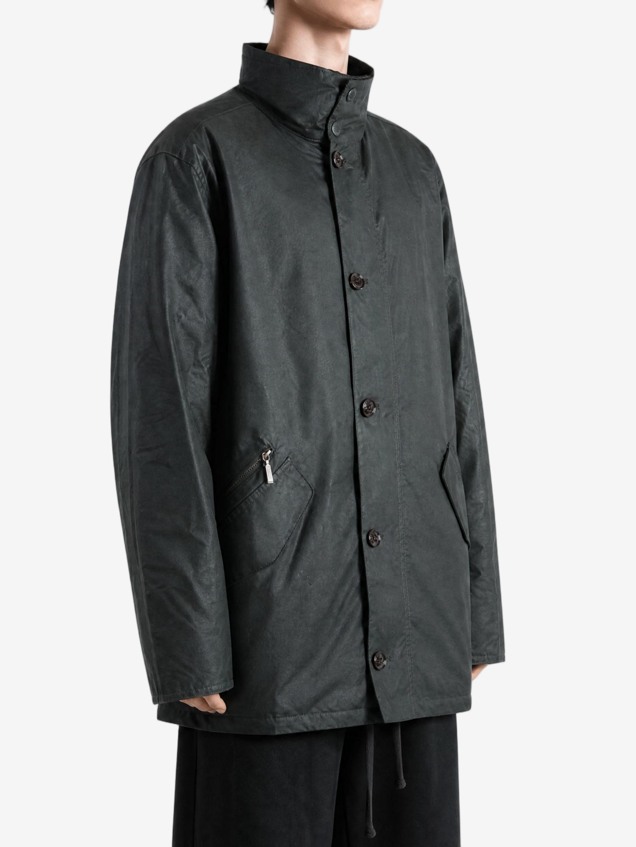 Green jacket worn by a person, showing the jacket fit