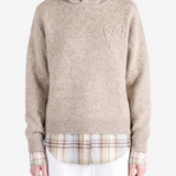 Tan knitwear worn by a person, showing the knitwear fit