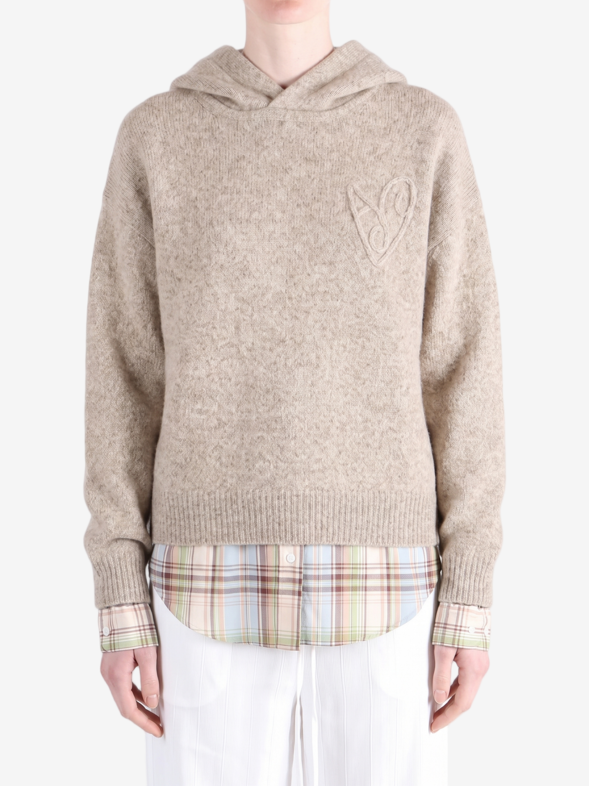 Tan knitwear worn by a person, showing the knitwear fit