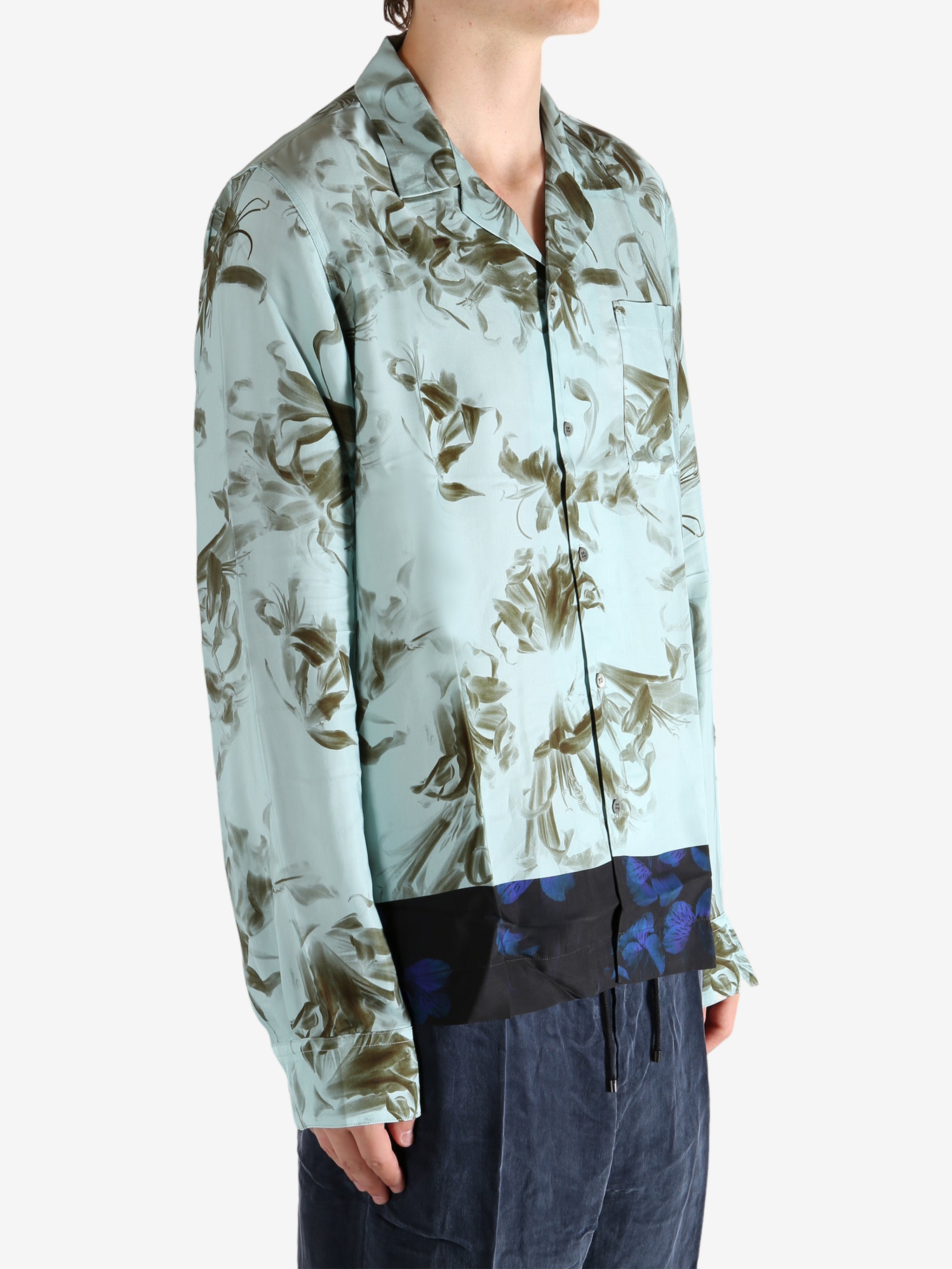 Green shirt worn by a person, showing the shirt's fit