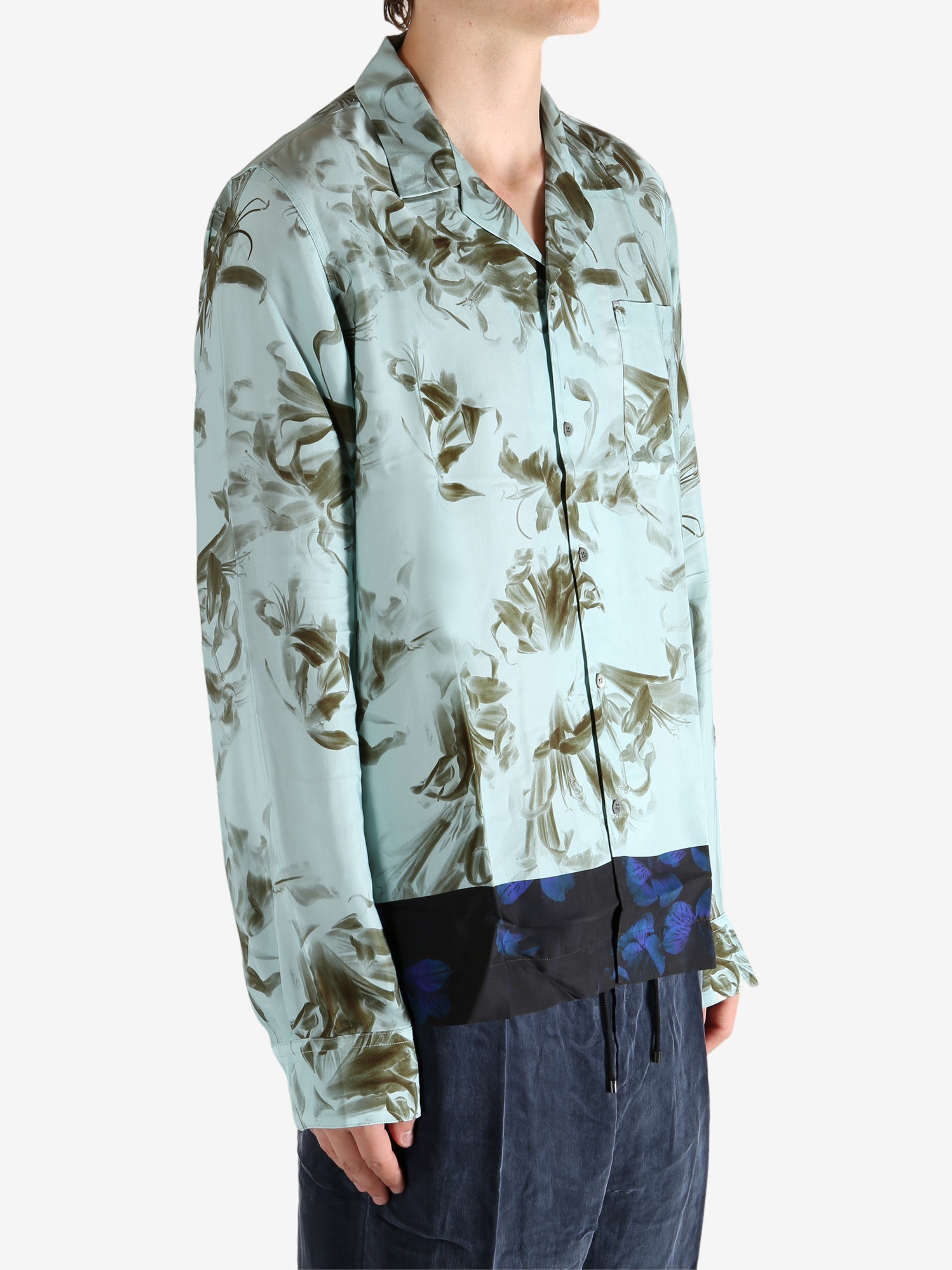 Green shirt worn by a person, showing the shirt's fit