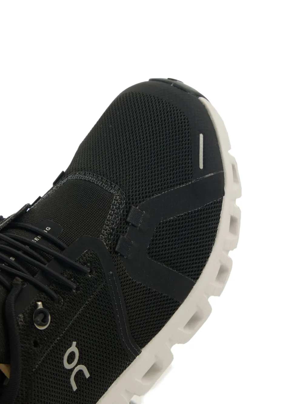 Close up of the black sneakers, showing texture of the polyester