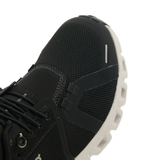 Close up of the black sneakers, showing texture of the polyester