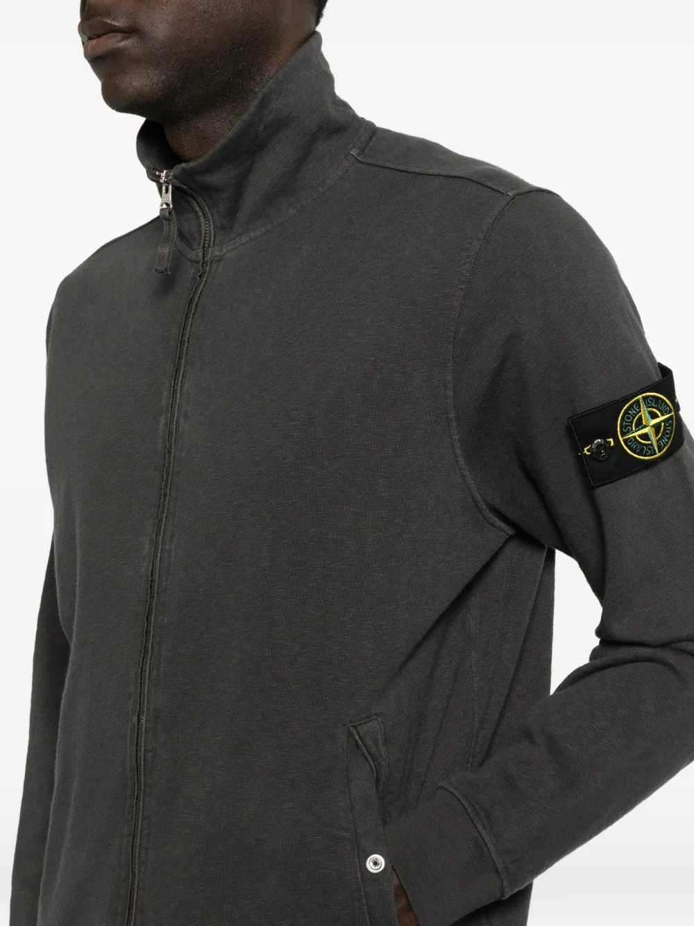 Close up of the grey jacket, showing texture of the cotton fabric