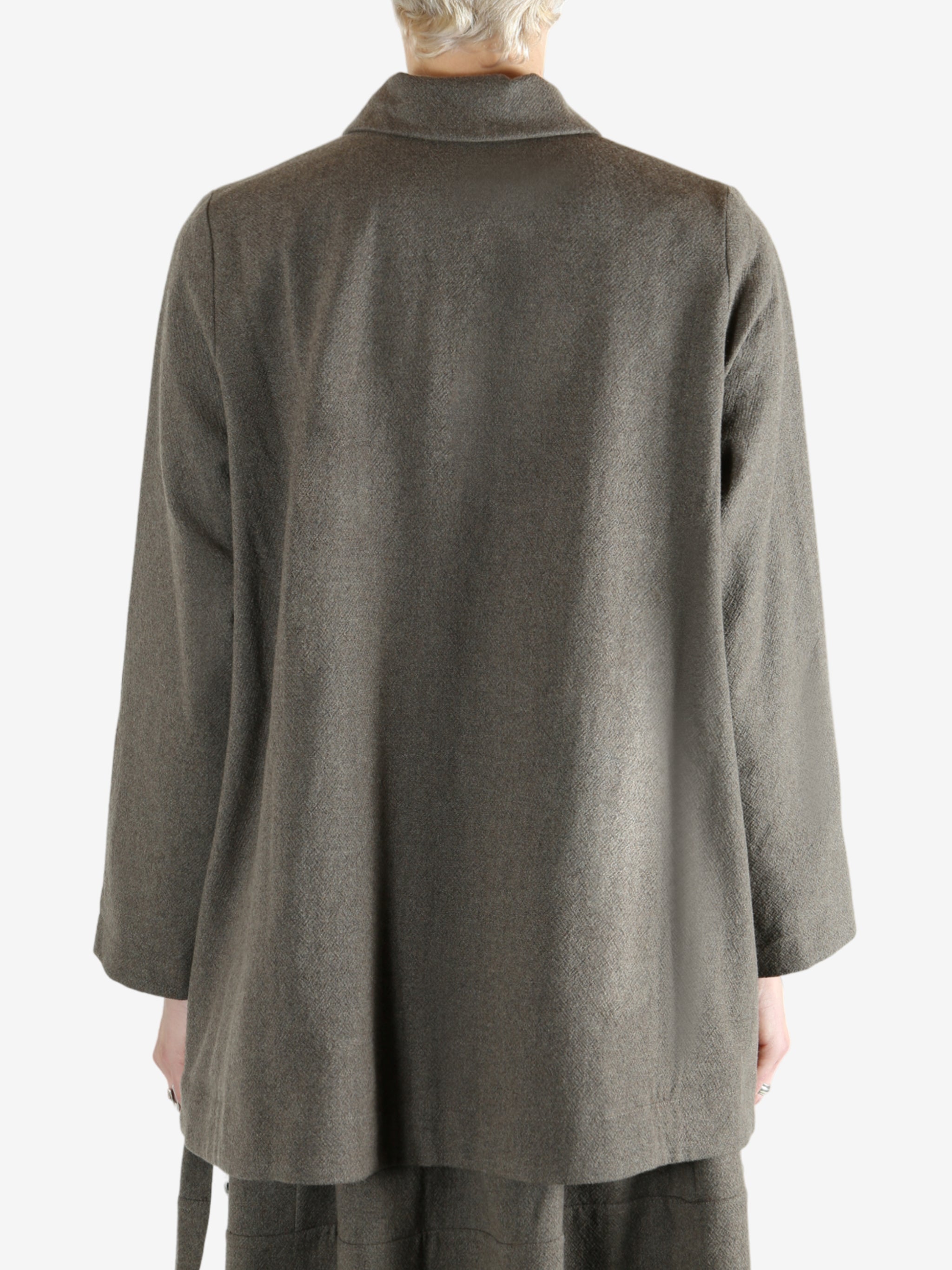 Grey coat worn by a person, showing the coat fit