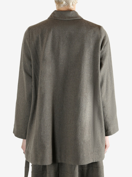 Grey coat worn by a person, showing the coat fit