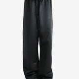 Black pants worn by a person, showing the pants fit