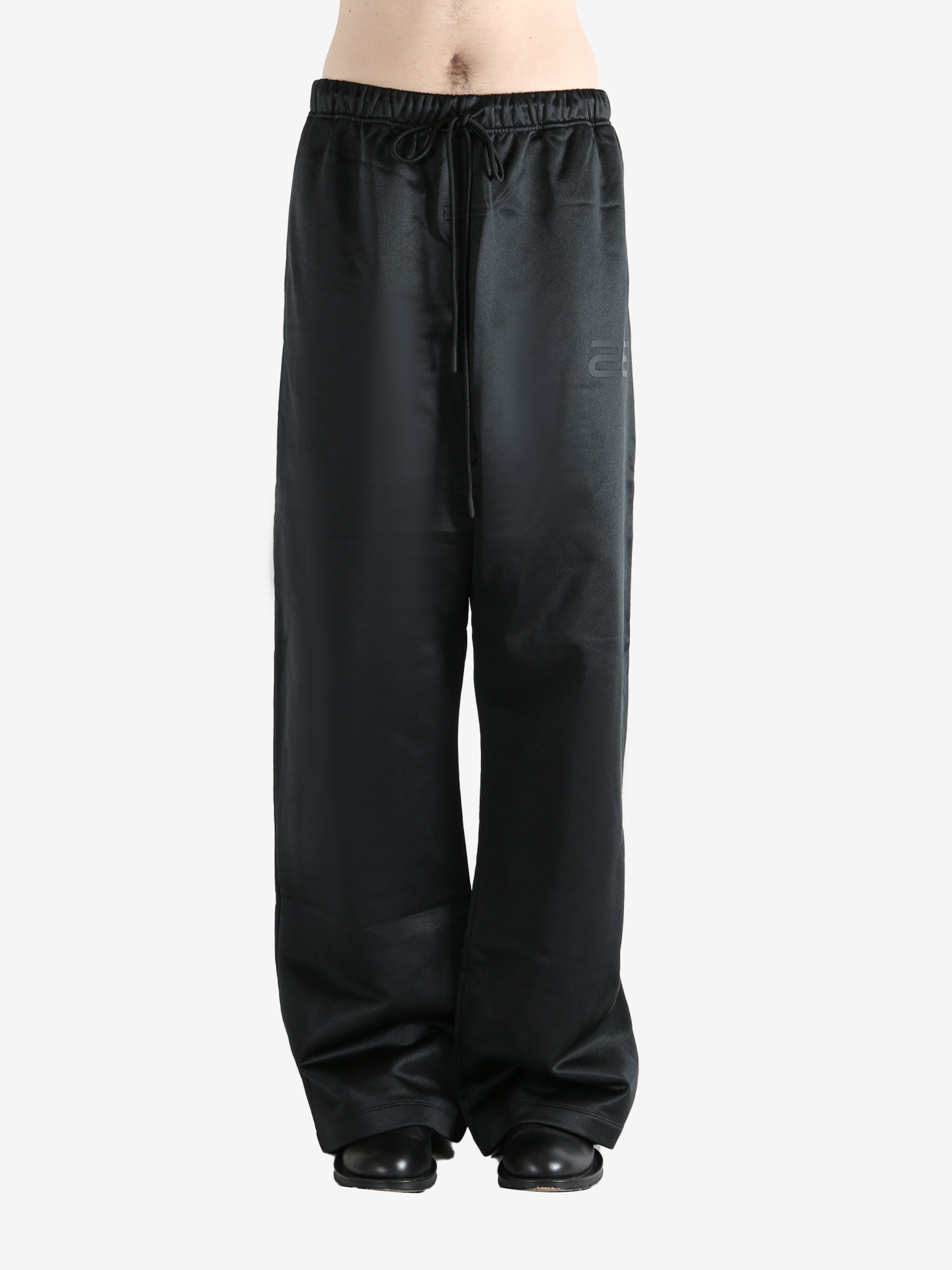 Black pants worn by a person, showing the pants fit