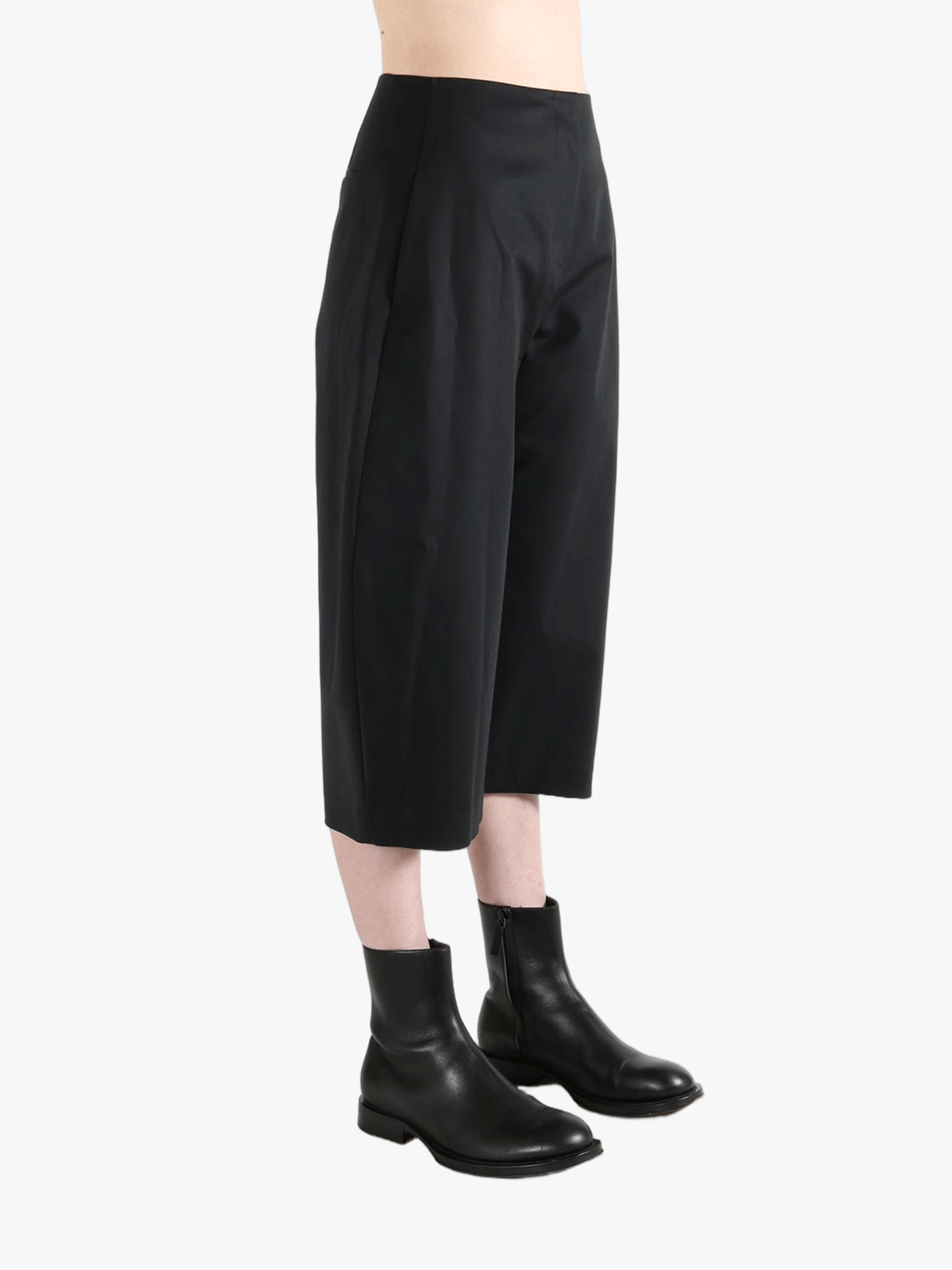Black pants worn by a person, showing the pants' fit