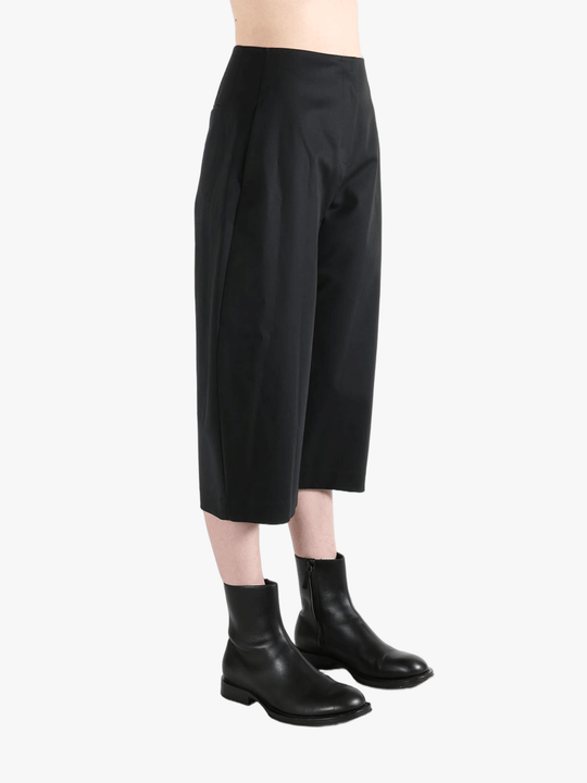 Black pants worn by a person, showing the pants' fit