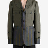 Green jacket worn by a person, showing the jacket fit