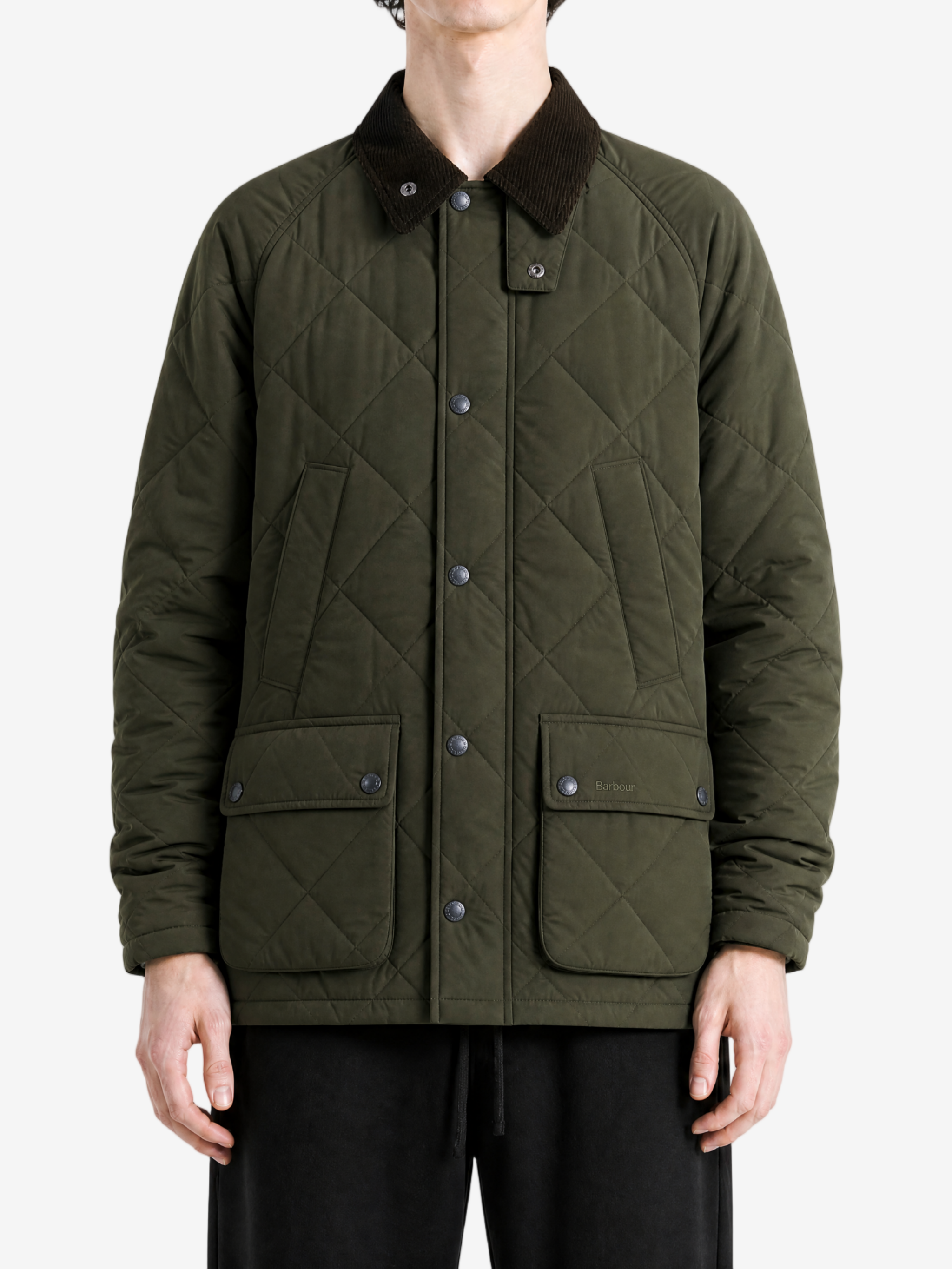 Green jacket worn by a person, showing the jacket fit