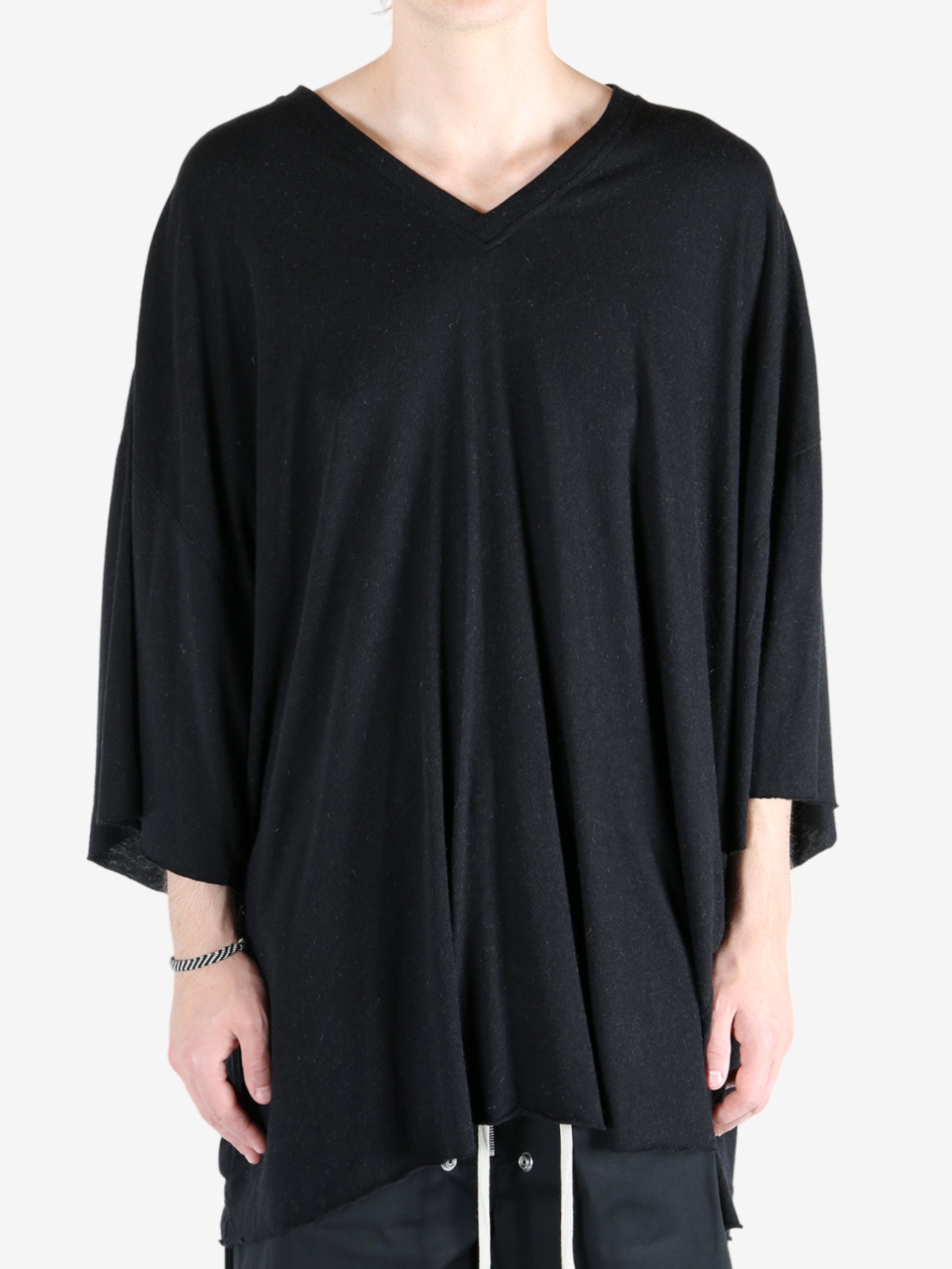 Black t-shirt worn by a person, showing the t-shirt fit