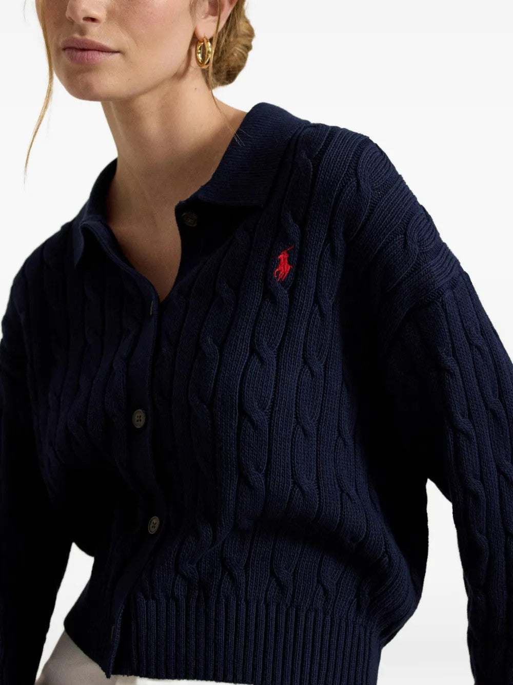 Navy knitwear worn by a person, showing the knitwear fit