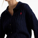 Navy knitwear worn by a person, showing the knitwear fit