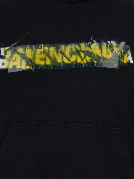 Close up of black hoodie, showing texture of the cotton fabric