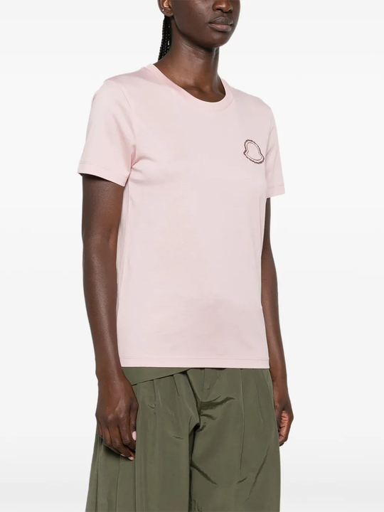 Pink t-shirt worn by a person, showing the t-shirt fit