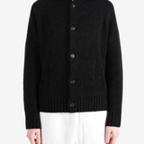 Black knitwear worn by a person, showing the knitwear fit