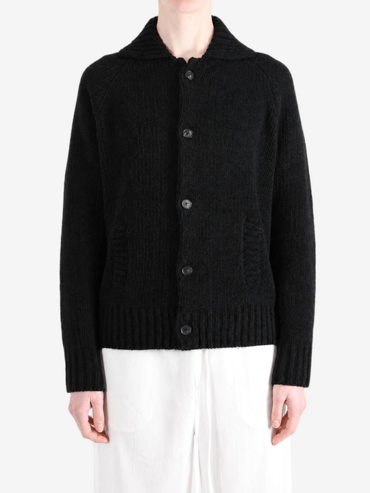 Black knitwear worn by a person, showing the knitwear fit