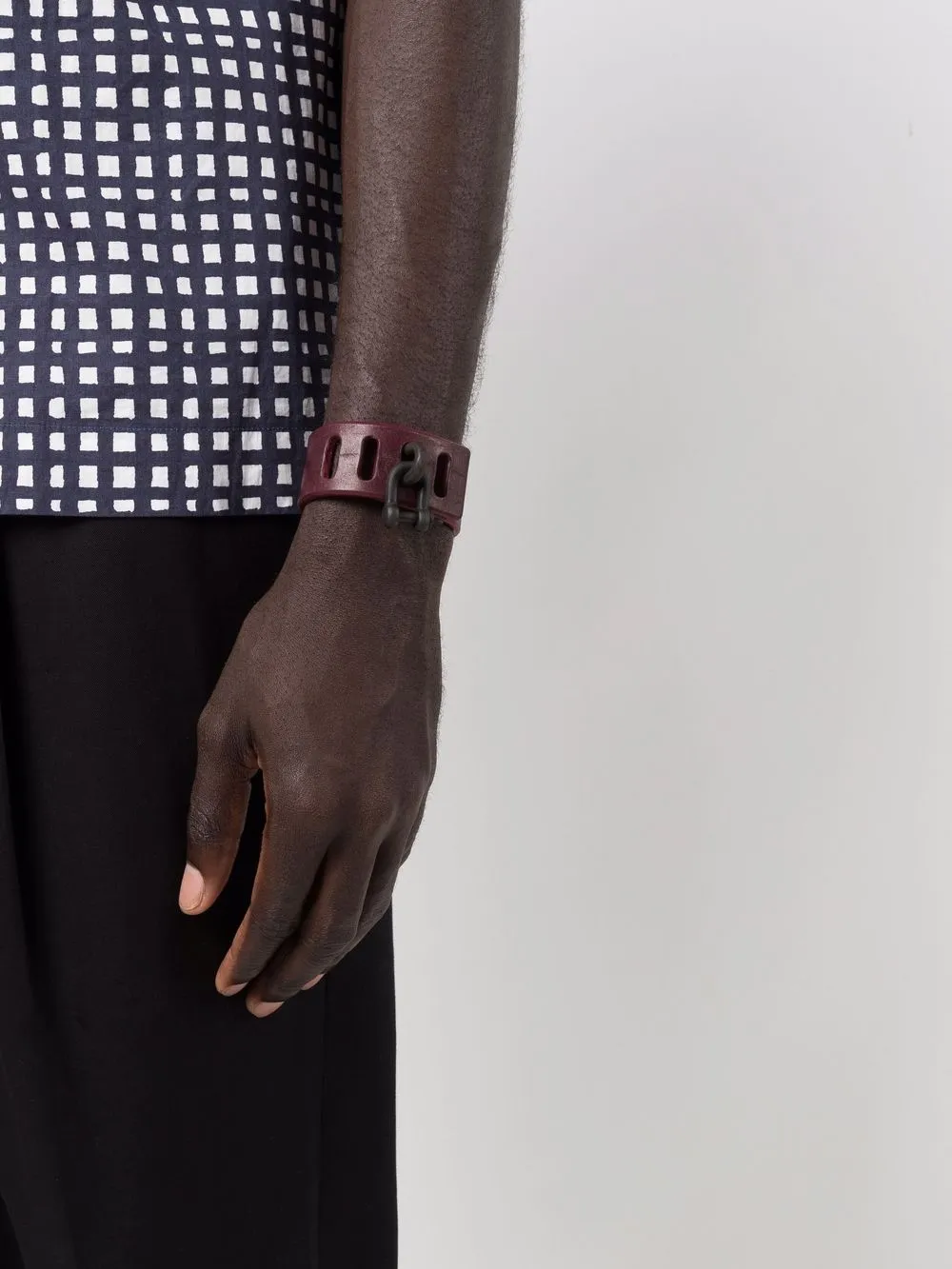 Red bracelet worn by a person, showing the bracelet fit