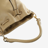 Close up of tan bag, showing texture of the cow leather fabric