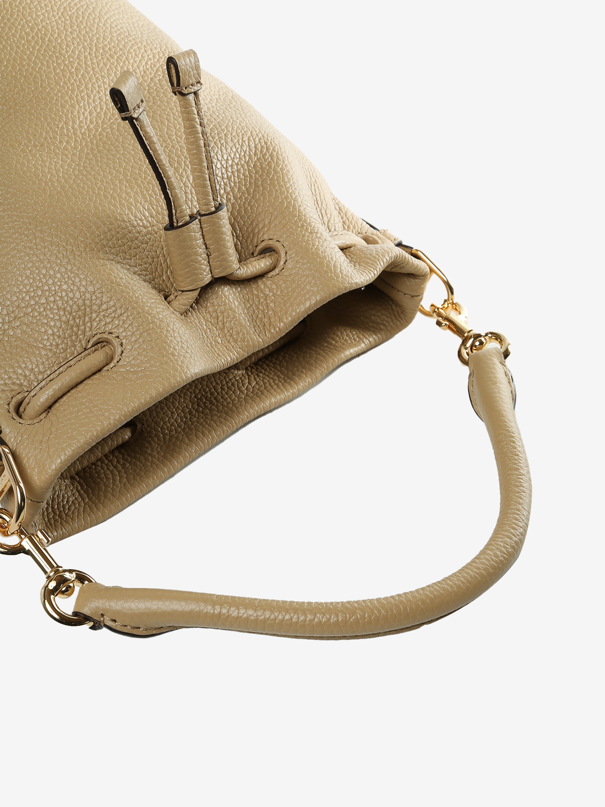 Close up of tan bag, showing texture of the cow leather fabric