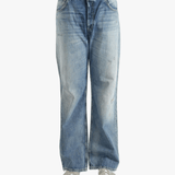 Blue jean worn by a person, showing the cow leather fit