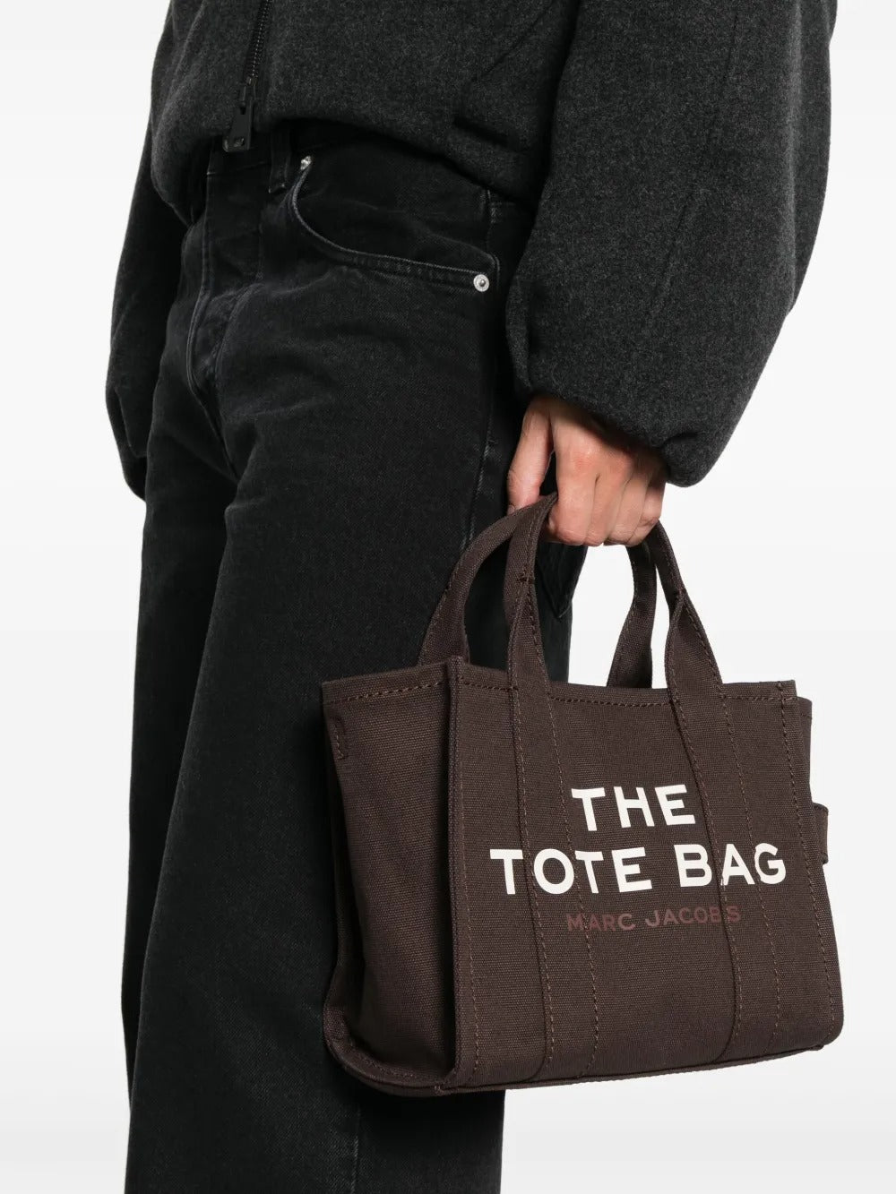 Brown bag carried by a person, showing the bag's size