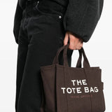 Brown bag carried by a person, showing the bag's size