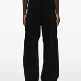 Black pants worn by a person, showing the pants' fit