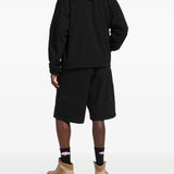 Black jacket worn by a person, showing the jacket's fit