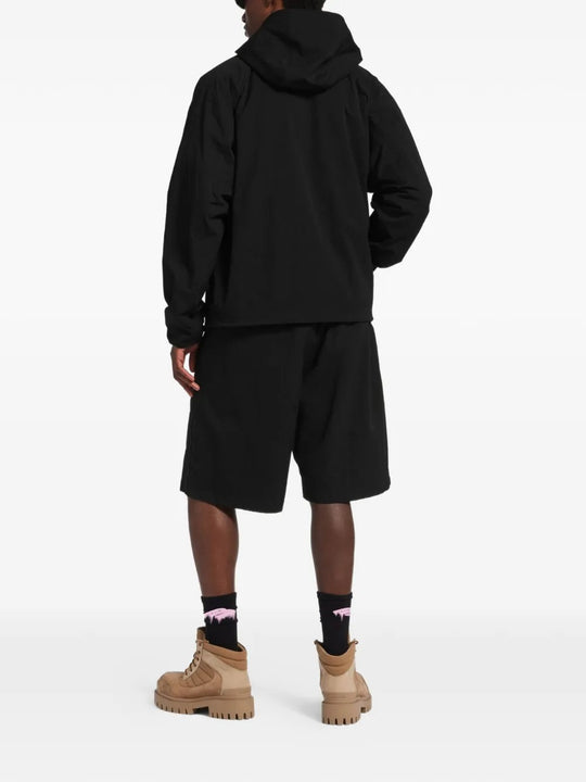 Black jacket worn by a person, showing the jacket's fit