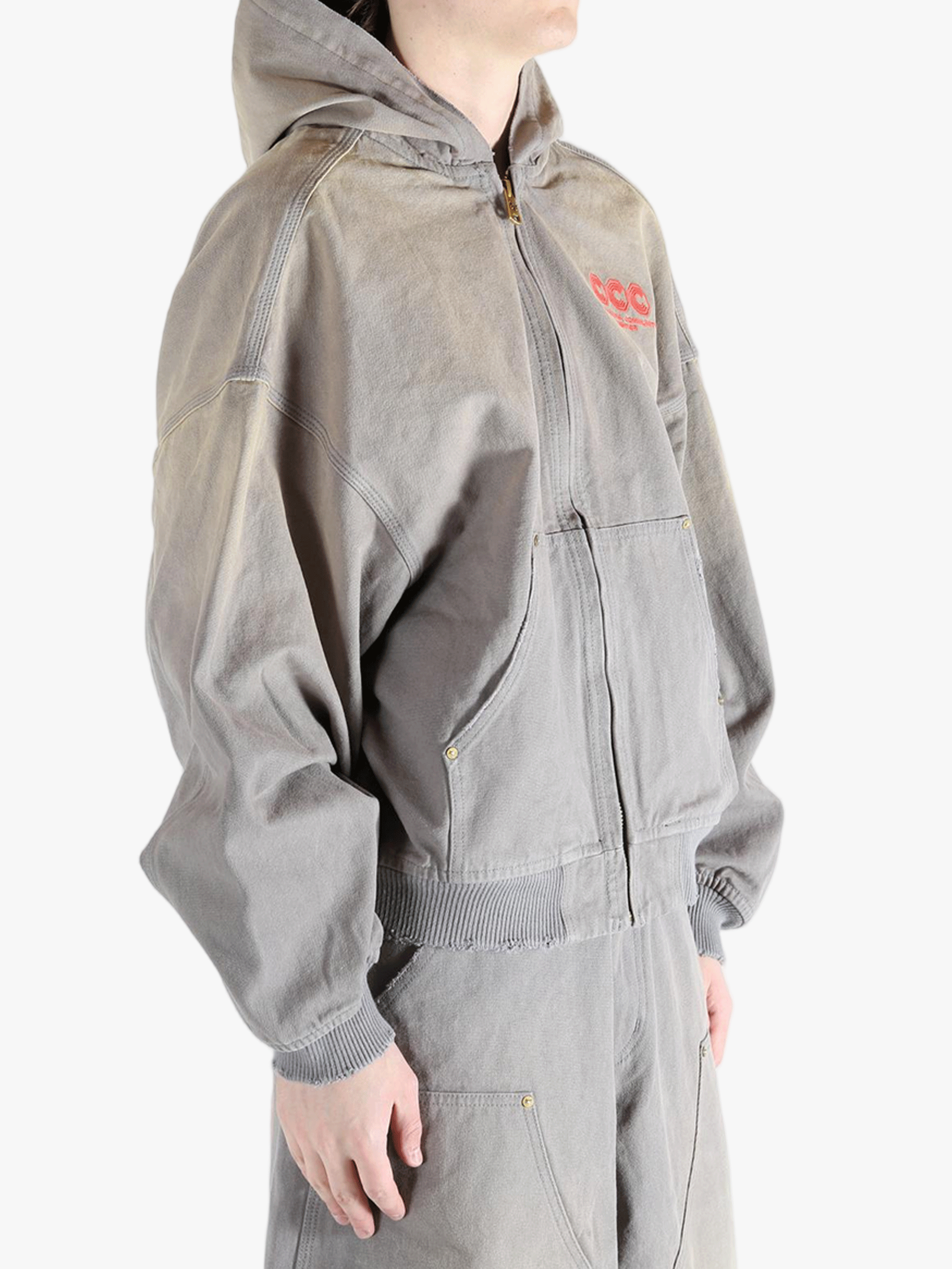 Grey hoodie, worn by a person, showing the hoodies fit