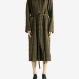 Green dress worn by a person, showing the dress fit